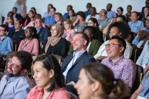 Smiling adults sitting in an auditorium